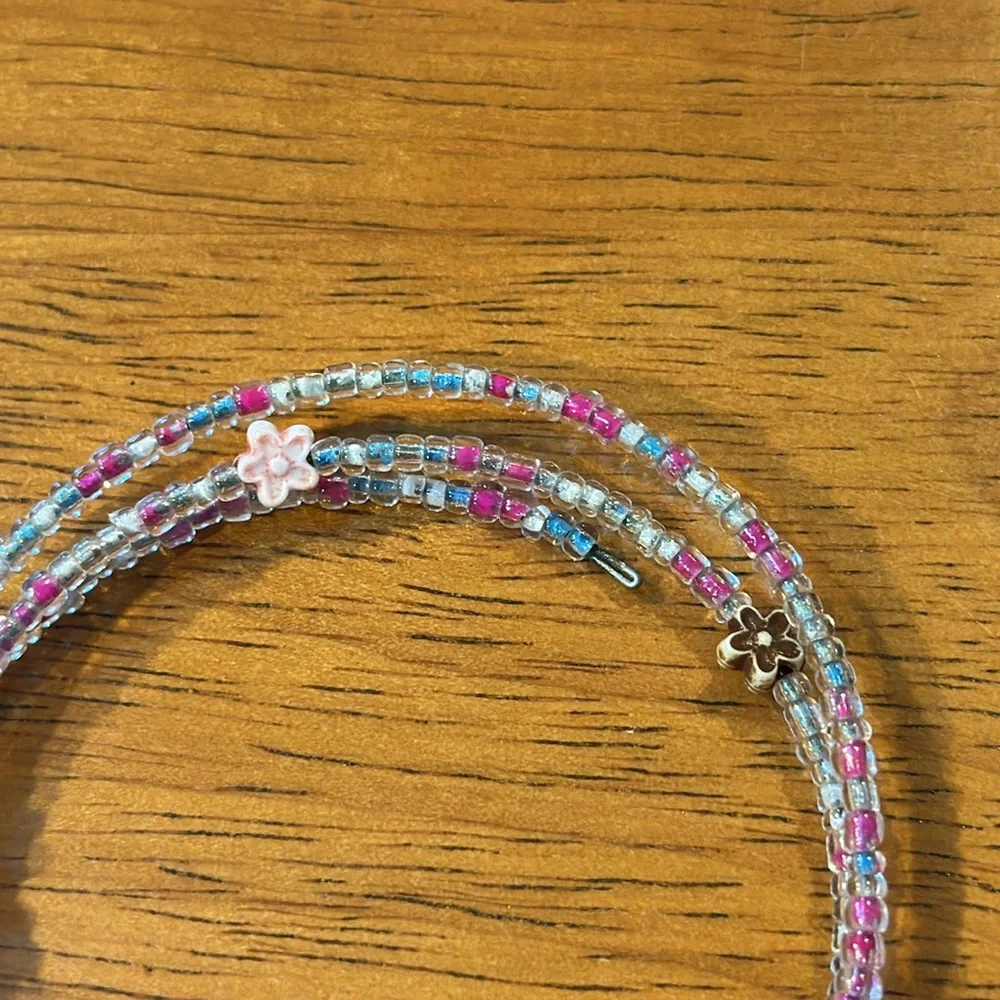 Handmade seed bead bracelet. Stretchy. Pink blue flowers.